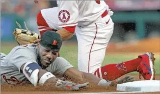  ?? Alex Gallardo Associated Press ?? AKIL BADDOO is tagged out at third base by the Angels’ Kean Wong trying to stretch a double.