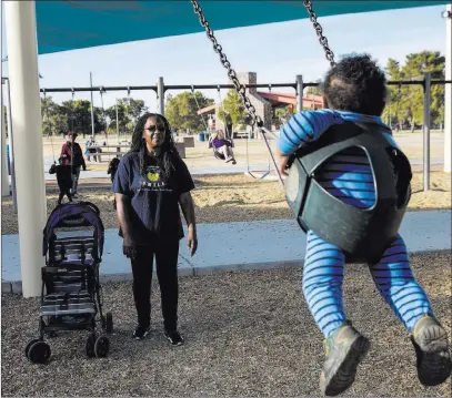  ?? Benjamin Hager ?? Las Vegas Review-journal North Las Vegas resident Theresa Igber, a teacher at Johnston Middle School, plays with her 1-year-old grandson at Craig Ranch Regional Park on Monday. “It’s disturbing when it involves kids,” she said of a string of recent shootings.