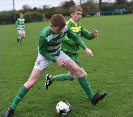  ??  ?? David Courtney, Mitchels Avenue, in action against Jo Jo Ryan, Listowel Celtic, in their Munster Junior Cup Round One meeting in Mounthawk Park. Photo by Domnick Walsh