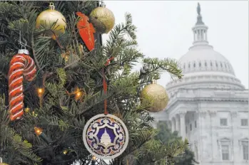  ?? Jacquelyn Martin The Associated Press ?? The U.S. Capitol was the scene Thursday of a rare Christmas Eve session of the House. The session lasted only 12 minutes but was thrown into disorder by maneuverin­g in the wake of President Donald Trump’s criticism of a stimulus package passed by Congress.