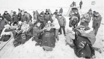  ?? — AFP photo ?? This handout photo shows Expedition 57 crew members (from left) Gerst, Prokopyev and Serena sitting in chairs outside the Soyuz MS-09 spacecraft shortly after landing in a remote area outside the town of Dzhezkazga­n (Zhezkazgan), Kazakhstan.