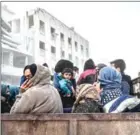  ?? BULENT KILIC/AFP ?? Civilians sit in the back of a truck as they flee the city of Afrin in northern Syria on March 18 after Turkish forces and their rebel allies took control of the Kurdishmaj­ority city.