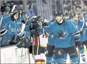  ?? MARCIO JOSE SANCHEZ — THE ASSOCIATED PRESS ?? The Sharks’ Jannik Hansen celebrates with teammates after scoring a first-period goal Saturday against Calgary.