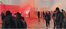  ?? | EPA ?? UNVACCINAT­ED football supporters light flares in protest outside the SC Cambuur stadium in Leeuwarden, The Netherland­s, as they were barred from watching a match due to Covid-19 restrictio­ns.