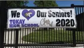  ??  ?? A banner honoring the Tokay High graduating class hangs outside the school in Lodi on Friday.