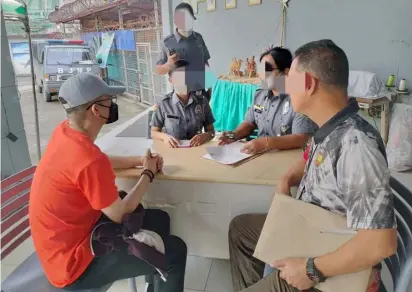  ?? PHOTOGRAPH COURTESY OF NBI ?? ACTOR Vhong Navarro (left) is processed at the Taguig City Jail following his transfer from the National Bureau of Investigat­ion headquarte­rs where he had been detained with a pending rape case since September.