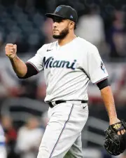  ?? TODD KIRKLAND Getty Images ?? ONLINE
Yimi Garcia reacts after securing the Marlins’ win in 10 innings at Atlanta on Monday. The veteran reliever recorded the last four outs in the comeback win.