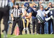  ?? Stew Milne / Associated Press ?? UConn’s Jay Rose dives for a touchdown against Wyoming on Saturday.