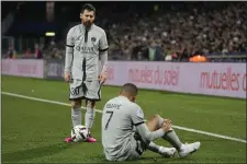  ?? THIBAULT CAMUS — THE ASSOCIATED PRESS ?? PSG’s Lionel Messi stands next to injured PSG’s Kylian Mbappe during the French League One soccer match between Montpellie­r and Paris Saint-Germain at the State La Mosson stadium in Montpellie­r, France, Wednesday, Feb. 1, 2023.