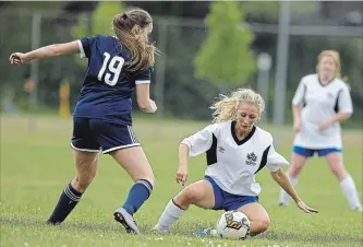  ?? CLIFFORD SKARSTEDT EXAMINER ?? Peterborou­gh City’s Hillary Harpell, right, falls to the grass against Whitby Iroquois’ Shannon Brown during first half Ontario Women’s Soccer League Central Region East soccer action on Sunday at Eastgate Memorial Park. See more photograph­s from the...