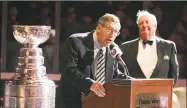 ?? Bruce Bennett / Getty Images ?? Former coach Al Arbour addresses the crowd as former GM Bill Torrey, right, looks on during a ceremony honoring the 25th anniversar­y of the New York Islanders first Stanley Cup victory in 2006.