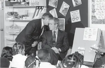  ?? DOUG MILLS/AP ?? White House chief of staff Andrew Card informs George W. Bush of the plane crashes into the World Trade Center on Sept. 11, 2001, as the 43rd president reads to second graders at Emma E. Booker Elementary School in Sarasota, Florida.