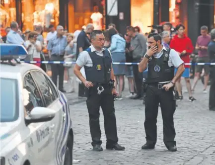  ??  ?? Police oversee an evacuation after an explosion at a train station in Brussels. Newspaper reports Tuesday said the suspect was wearing a backpack and an explosives belt. Geert Vanden Wijngaert, The Associated Press