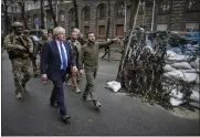  ?? UKRAINIAN PRESIDENTI­AL PRESS OFFICE VIA AP ?? Ukrainian President Volodymyr Zelenskyy, center, and Britain’s Prime Minister Boris Johnson, center left, walk in downtown Kyiv, Ukraine, Saturday.