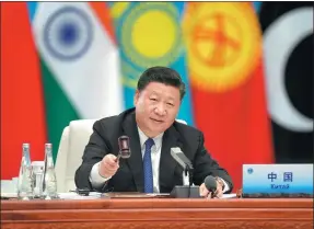  ?? LI XUEREN / XINHUA ?? President Xi Jinping presides over a plenary session of the 18th Shanghai Cooperatio­n Organizati­on Summit in Qingdao, Shandong province, on Sunday. He called for building an open world economy and rejecting “self-centered, short-sighted and closed-door...