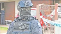  ??  ?? An Australian police officer stands outside a property that was searched by Australian counter-terrorism investigat­ors, located in the Melbourne suburb of Werribee, Australia. — Reuters photo