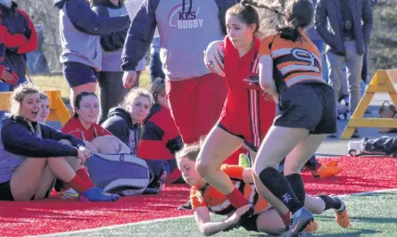  ?? PHOTOS BY CAROLE MORRIS-UNDERHILL ?? Jada MacKinnon, from Barrington, N.S., plows through the competitio­n as her KES teammates watch and cheer her on from the sidelines.