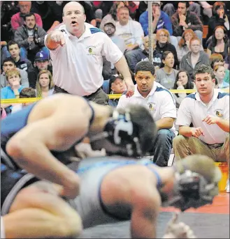  ?? ABIGAIL PHEIFFER/THE DAY ?? Ledyard head coach Steve Bilheimer, left, shouts instructio­ns to one of his wrestlers during the ECC Tournament at Fitch High School in Groton on February 12, 2011.