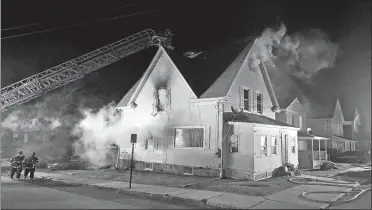  ?? SEAN D. ELLIOT/THE DAY ?? New London firefighte­rs battle a fire at 47 Summer St. Friday.