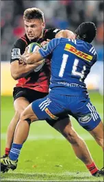  ?? Picture: GETTY IMAGES ?? UNDER PRESSURE: George Bridge, of the Crusaders, charges forward against the Stormers’ Cheslin Kolbe during their Super Rugby match in New Zealand at the weekend