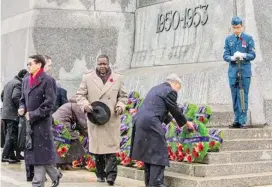  ??  ?? Dignitarie­s lay wreaths to honour the war dead on Monday during the solemn National Remembranc­e Day Ceremony at the National War Memorial in Ottawa.