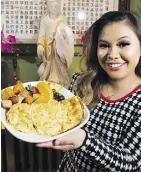  ?? GREG SOUTHAM ?? Maya Paramitha shows off Padmanadi Vegetarian Restaurant’s Spicy Eggplant Omelette, one of the eatery’s weekend brunch specialtie­s.