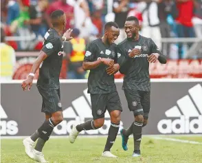  ??  ?? Pirates’ Justin Shonga (centre) celebrates his winning goal with teammates during last Saturday’s derby.