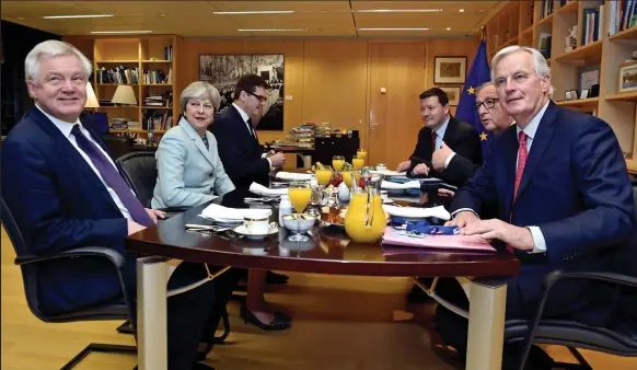  ??  ?? Pass the croissants: Mrs May and David Davis sit down for breakfast with Mr Juncker and EU chief negotiator Michel Barnier