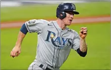  ?? ERIC GAY/AP PHOTO ?? Tampa Bay’s Joey Wendle gets ready to round first after hitting a two-run double during the fourth inning of the Rays’ 6-4 win over the Los Angeles Dodgers in Game 2 of the World Series on Wednesday.