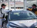  ?? Erik Verduzco ?? Las Vegas Review-journal Jeremy Roenick, left, talks things over with NASCAR driver Brendan Gaughan before driving hot laps Wednesday at Las Vegas Motor Speedway.