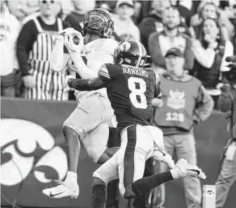  ?? Charlie Neibergall / Associated Press ?? Purdue wide receiver David Bell catches a 21-yard touchdown pass over Iowa defensive back Matt Hankins on Saturday. Bell had 11 catches for a Kinnick Stadium-record 240 yards.