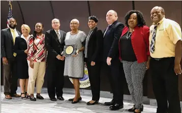  ?? TONY DORIS / THE PALM BEACH POST ?? Riviera Beach officials accept the award from the national Government Finance Officers’ Associatio­n on Wednesday. Nationwide, 1,580 municipali­ties won the award this year.