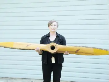  ?? TROY FLEECE ?? Lois Wilson holds a propeller that belonged to RCAF pilot Max Thomas, who died in a plane crash in Estevan after returning leased planes to the United States in 1946.