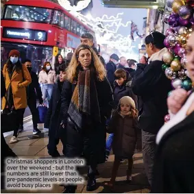  ?? ?? Christmas shoppers in London over the weekend - but the numbers are still lower than pre-pandemic levels as people avoid busy places