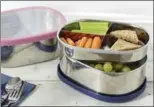  ?? PHOTOS BY POTTERY BARN KIDS/TEENS VIA AP ?? Forgo the plastic and foil wrap by stowing lunch treats in a washable stainless steel bento box.