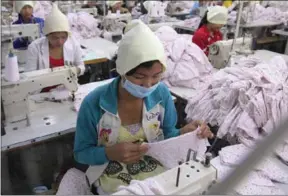 ?? PHA LINA ?? A worker stitches fabric in a garment factory in 2013.