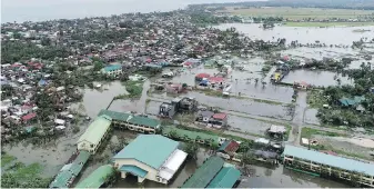  ??  ?? Floodwater inundates a village in Sorsogon province. Vongfong was expected to blow out of the northern Philippine­s on Sunday.