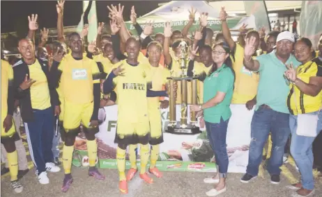  ??  ?? The victorious Chase Academy unit posing with the championsh­ip trophy alongside M.Beepat and Sons Marketing Manager Renita Seethal, after they defeated Morgan Learning Center (MLC) via penalty kicks to retain the Milo Secondary School football title at...