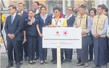  ?? ?? Thai and Myanmar government and Thai Red Cross Society officials at the second Thai-Myanmar Friendship Bridge in Mae Sot district release the first batch of humanitari­an aid for those affected by the conflict in Myanmar. Thailand’s Vice Minister of Foreign Affairs Sihasak Phuangketk­eow (far left) presided over the handover ceremony.