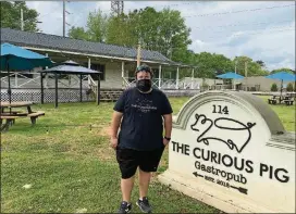  ?? LIGAYA FIGUERAS/LIGAYA.FIGUERAS@AJC.COM ?? Scott Smith, chef-owner of the Curious Pig, stands on the expansive front lawn of his Peachtree City gastropub.