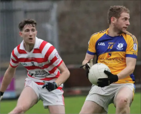  ??  ?? Seamus McLoughlin of Taghmon-Camross looks for a colleague as Pádraig Bolger (Ferns St. Aidan’s) tries to close him down.