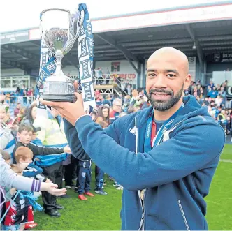  ??  ?? Liam Fontaine with the Championsh­ip silverware at Ross County in 2019.