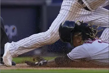  ?? FRANK FRANKLIN II — THE ASSOCIATED PRESS ?? The Guardians' Jose Ramirez dives safely into third base ahead of the throw to Yankees third baseman Josh Donaldson after hitting a double and advancing on a throwing error during the 10th inning of Game 2of their AL Division Series on Friday in New York.