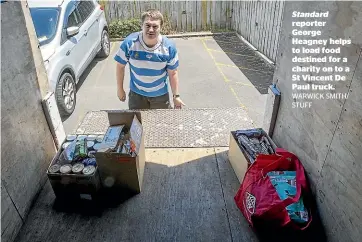  ?? WARWICK SMITH/ STUFF ?? Standard reporter George Heagney helps to load food destined for a charity on to a St Vincent De Paul truck.