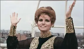  ?? (AP) ?? Raquel Welch throws up her hands in dismay as it begins to rain as she looks at the London skyline during a party held at the Dorchester Hotel, Park Lane on April 27, 1969.