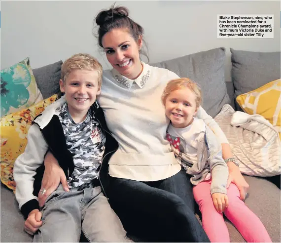  ??  ?? Blake Stephenson, nine, who has been nominated for a Chronicle Champions award, with mum Victoria Duke and five-year-old sister Tilly