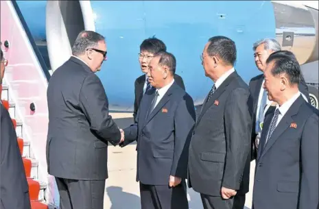  ?? Matthew Lee/AFP/Getty Images ?? U.S. Secretary of State Mike Pompeo, left, is greeted by senior North Korean officials on his arrival Wednesday in Pyongyang, North Korea. Pompeo met with North Korean leader Kim Jong Il later and secured the release of three American prisoners ahead...