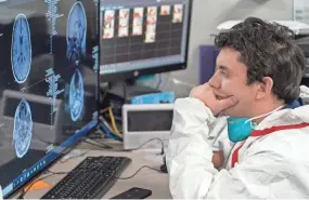  ?? NAKAMURA/GETTY IMAGES GO ?? Gabriel Cervera Rodriguez examines a patient’s MRI images in the COVID-19 intensive care unit at Houston’s United Memorial Medical Center in 2020.