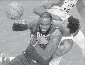  ?? AP/The Canadian Press/FRED THORNHILL ?? Cleveland forward LeBron James is fouled by Toronto’s Kyle Lowry during the Cavaliers’ 128-110 victory over the Raptors on Thursday in Game 2 of their NBA Eastern Conference semifinal series at the Air Canada Centre in Toronto. James led the Cavaliers...