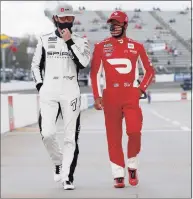  ?? Brian Lawdermilk / Getty Images ?? Bubba Wallace, driver of the No. 23 DoorDash Toyota, and Corey LaJoie, driver of the No. 7 ARK.io Chevrolet, walk the grid prior to the NASCAR Cup Series Blue-Emu Maximum Pain Relief 500 at Martinsvil­le Speedway on April 11 in Martinsvil­le, Va. Wallace says he has been vaccinated against COVID-19.